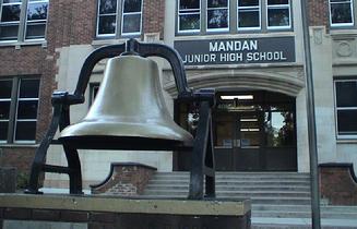 The Central School bell displayed on an outdoor pedestal