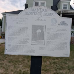 A Heritage Home sign for the Haskins Home with the house behind it