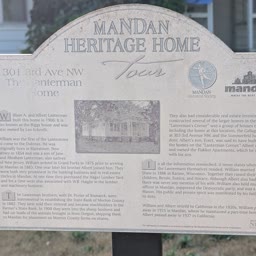 A weathered Heritage Home sign for the Lanterman Home