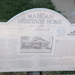 A weathered Heritage Home sign for the Nickerson Home