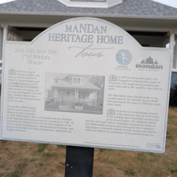 A Heritage Home sign for the Welsh Home at 208 5th Avenue NW